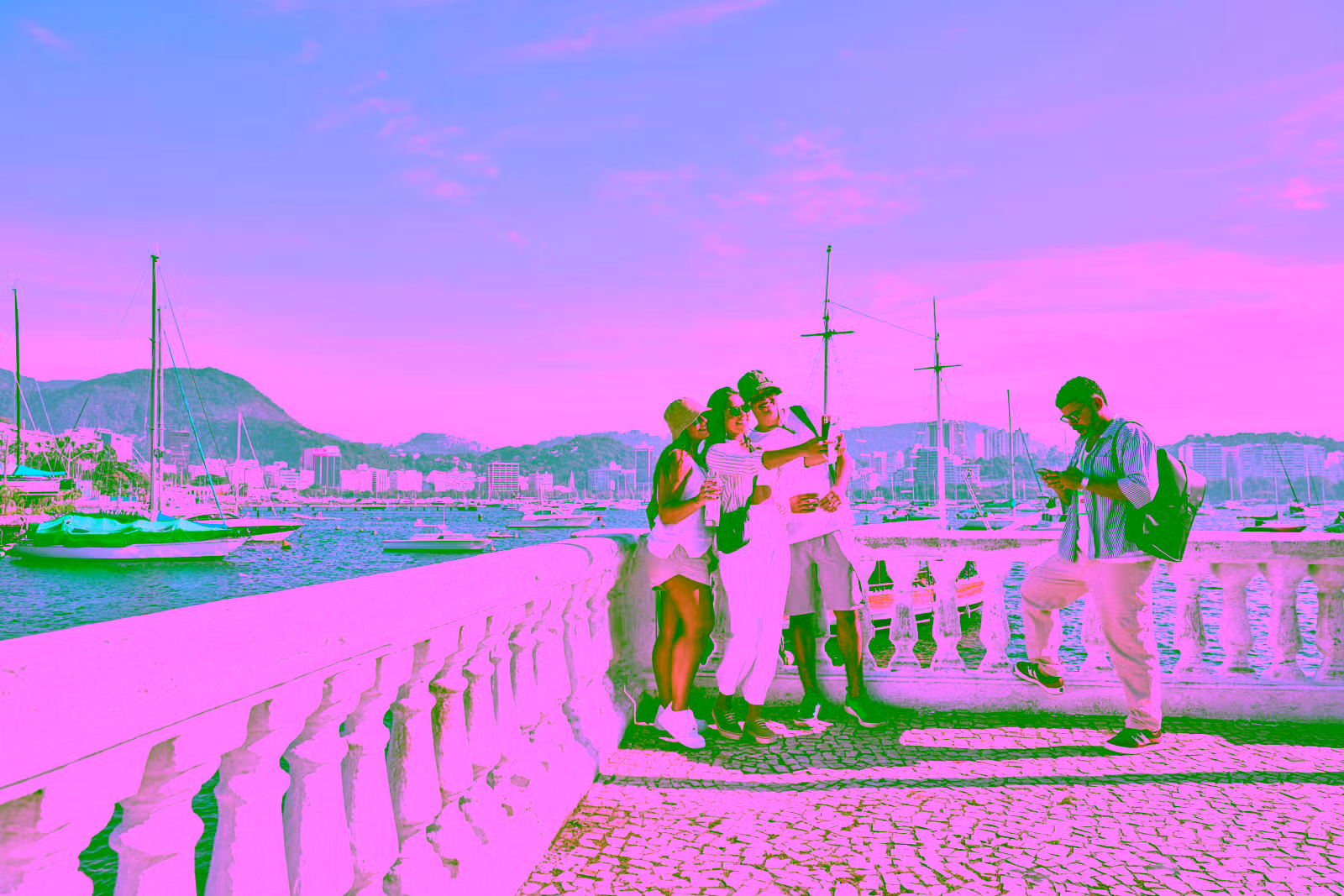People overlooking a bay with boats
